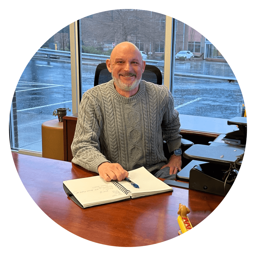 man smiling handling billing invoices behind desk